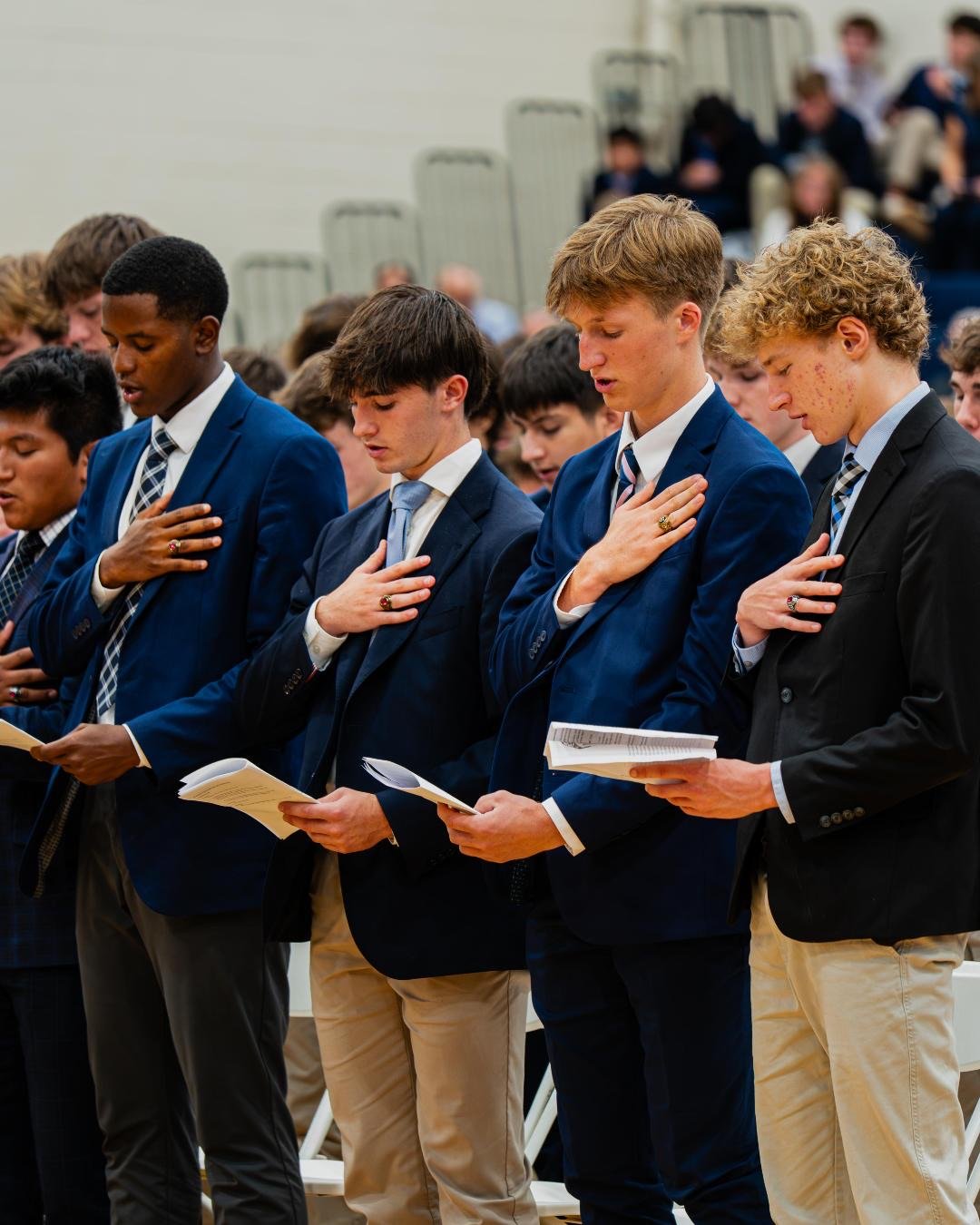 Seniors with hands on their hearts during the Senior Ring Mass
